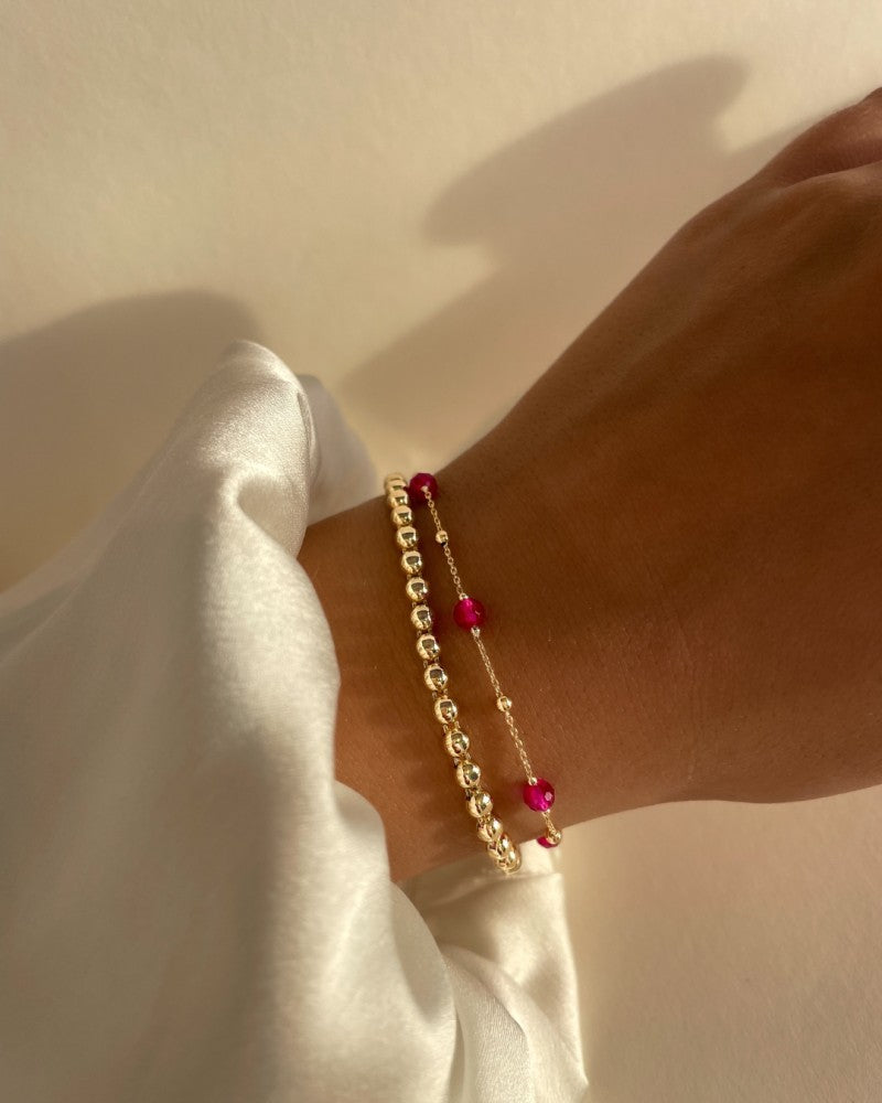 Geschmeidiges Armband aus Gelbgold mit goldenen Kügelchen – Eleganz in Schlichtheit