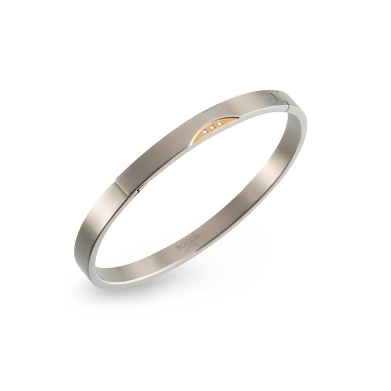 Bicolor Armband aus Titan mit goldfarbener Akzentfläche und drei kleinen Zirkonia-Steinen