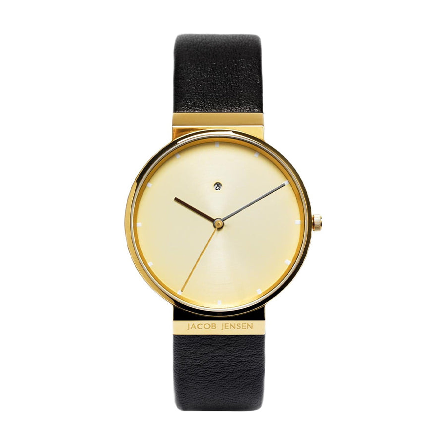 Uhr mit goldenem Gehäuse und beigem Zifferblatt, schwarzem Lederarmband und minimalistischen Zeigern