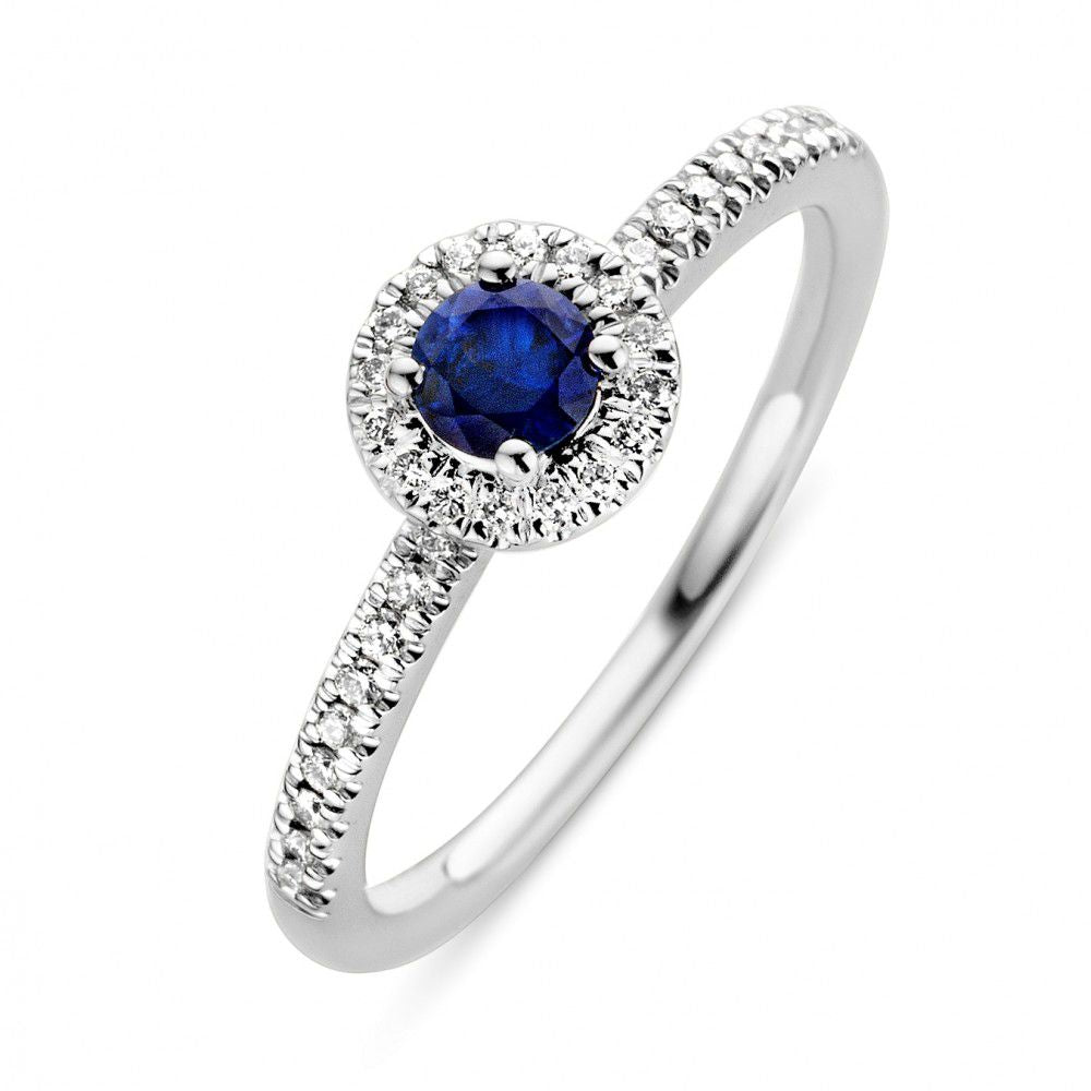 Ring aus Weißgold mit blauem Saphir und Diamanten, runder Stein in der Mitte, schmale, funkelnde Fassung