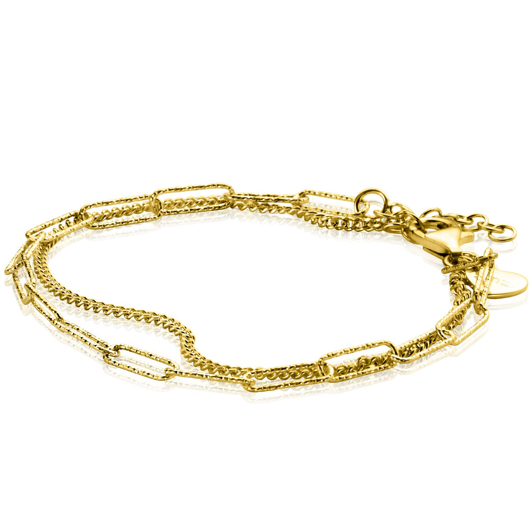 De Zinzi Armband Gold Plated Zia2367 G enkelband toont een mix van paperclip- en fijne kettingschakels met een verstelbare sluiting en bedel, die elegantie belichamen. Deze vergulde accessoire wordt weergegeven op een witte achtergrond en voegt verfijning toe aan elke look.