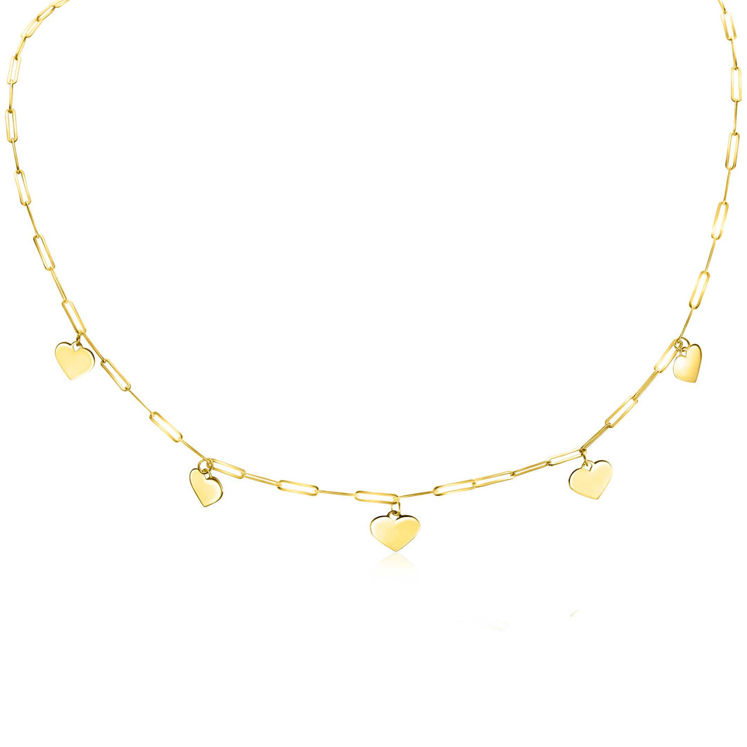 De Zinzi Ketting Goud Zgc342 is een delicate ketting van Zinzi, met vijf kleine hartvormige hangers die kunstig zijn geplaatst langs elegante paperclipschakels. De langwerpige schakels creëren een eenvoudige maar verfijnde uitstraling, perfect gepresenteerd tegen een witte achtergrond.